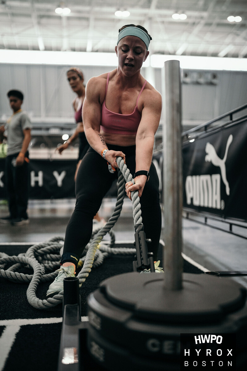 Athlete pushing a HYROX sled